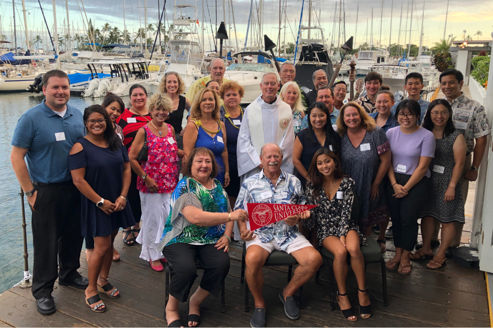 A group of people in front of a marina 