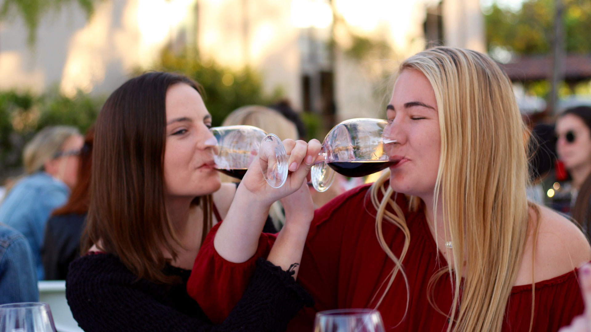 Two women sipping wine 