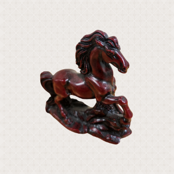 A dark red, carved wooden horse.