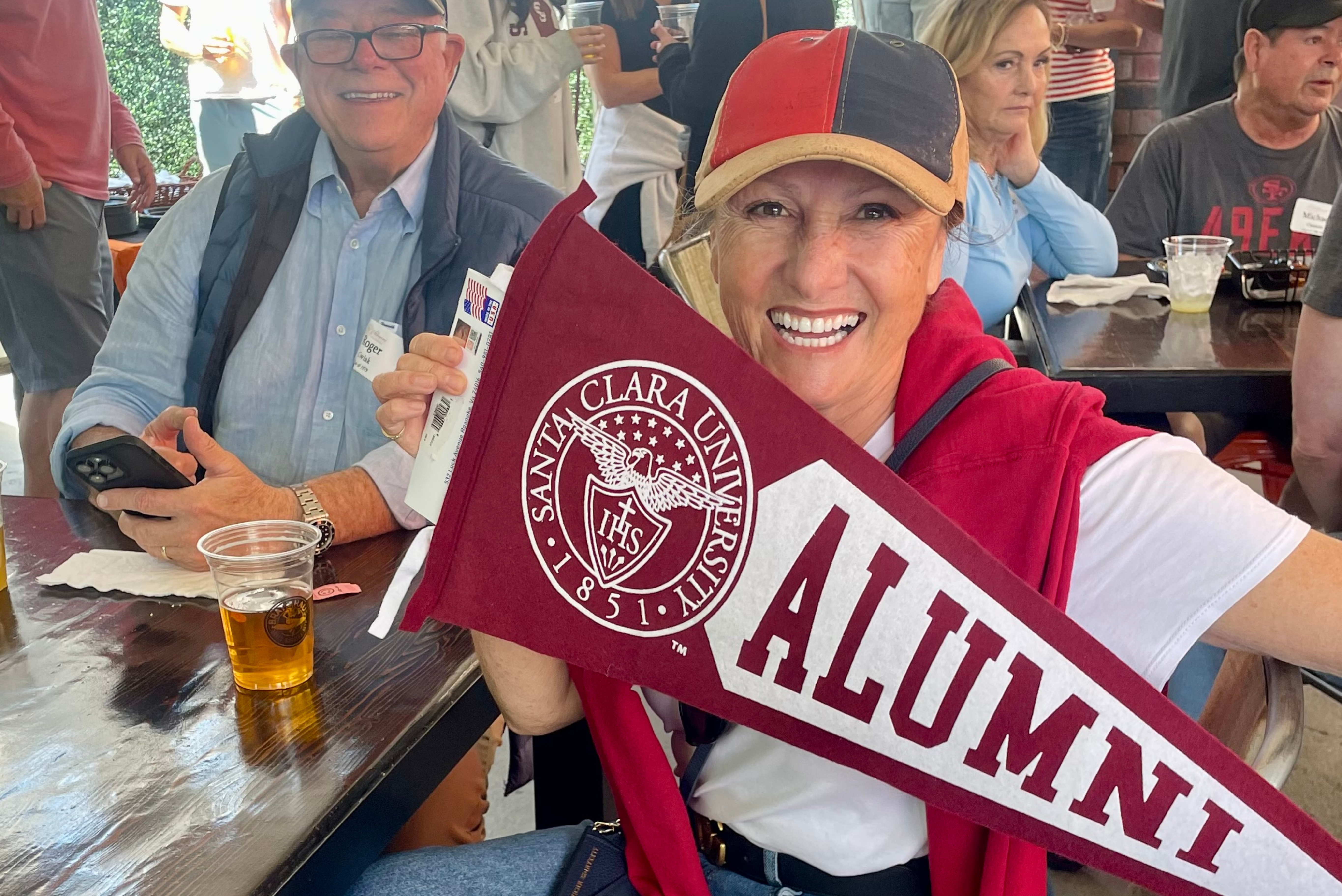 Alumni holding alumni banner