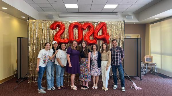 ISS Staff posing at 2024 Graduation photobooth