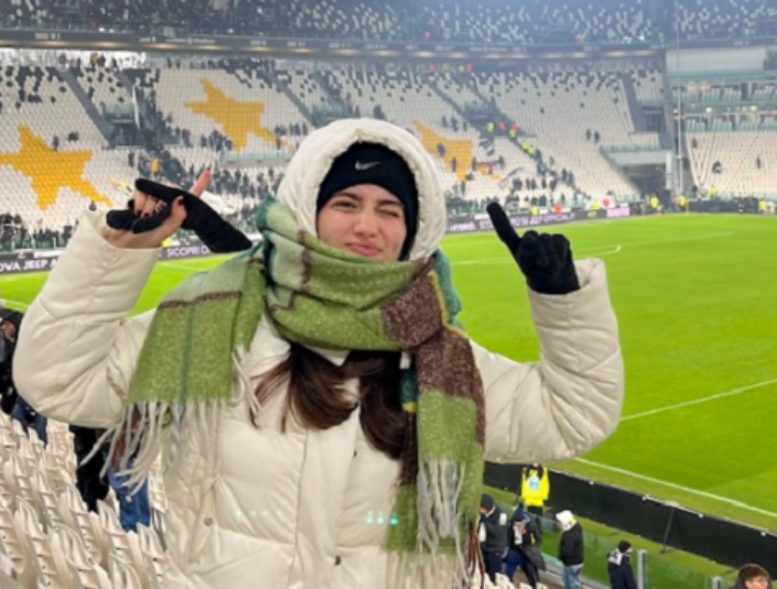Decorative; student standing in a soccer stadium 