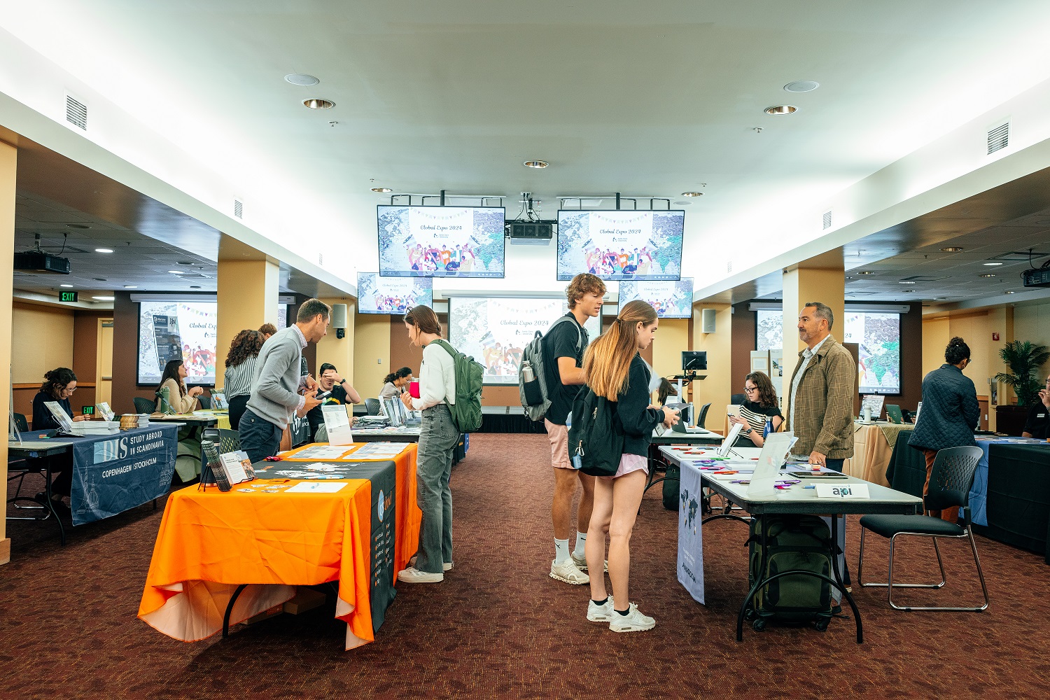 Decorative; students at Global Expo speaking to program providers 