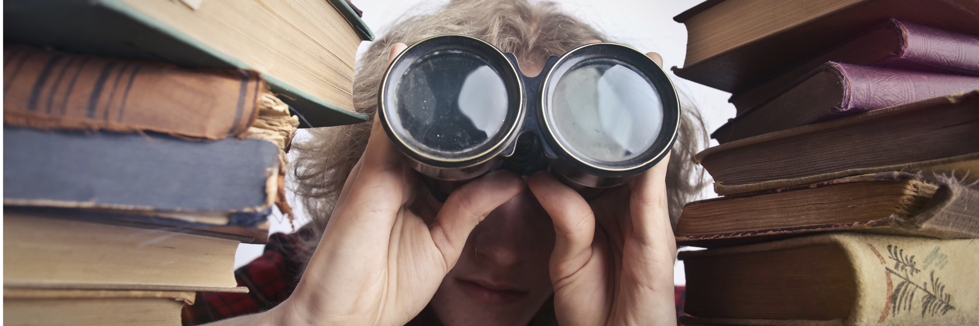 Search for What Matters Person with binoculars and stacks of books 