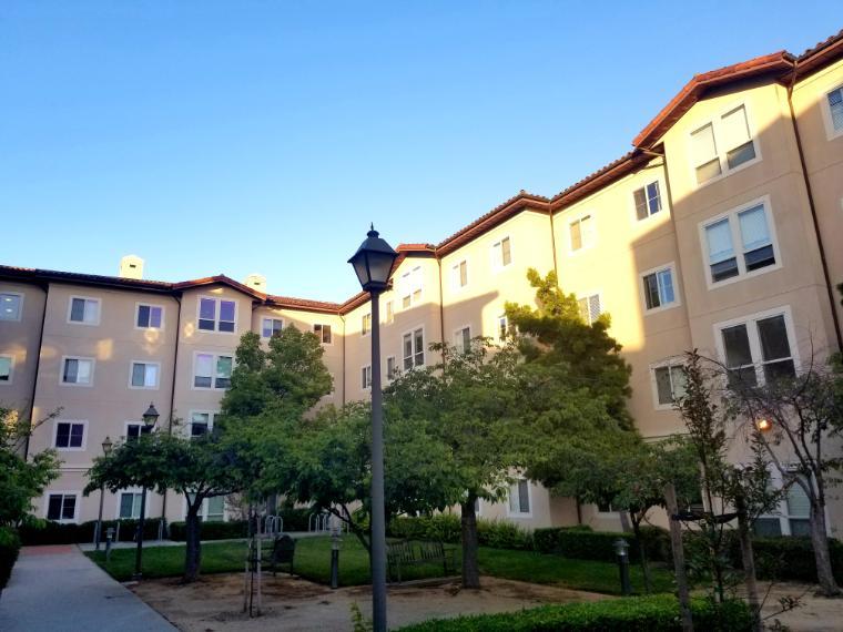 Courtyard surrounded by multi-story buildings with a central garden.