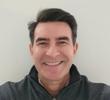 Image of man smiling with short dark hair