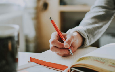 student writing in notebook 