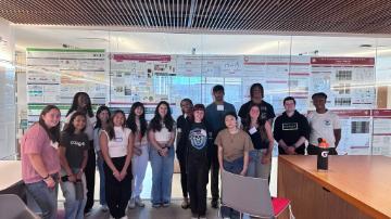 Students standing in front of science posters 
