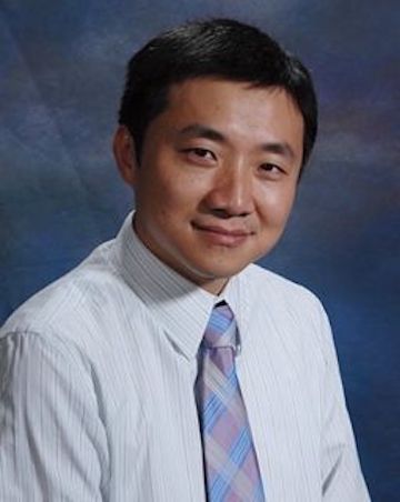 A professionally dressed person smiles against a studio background. image link to story