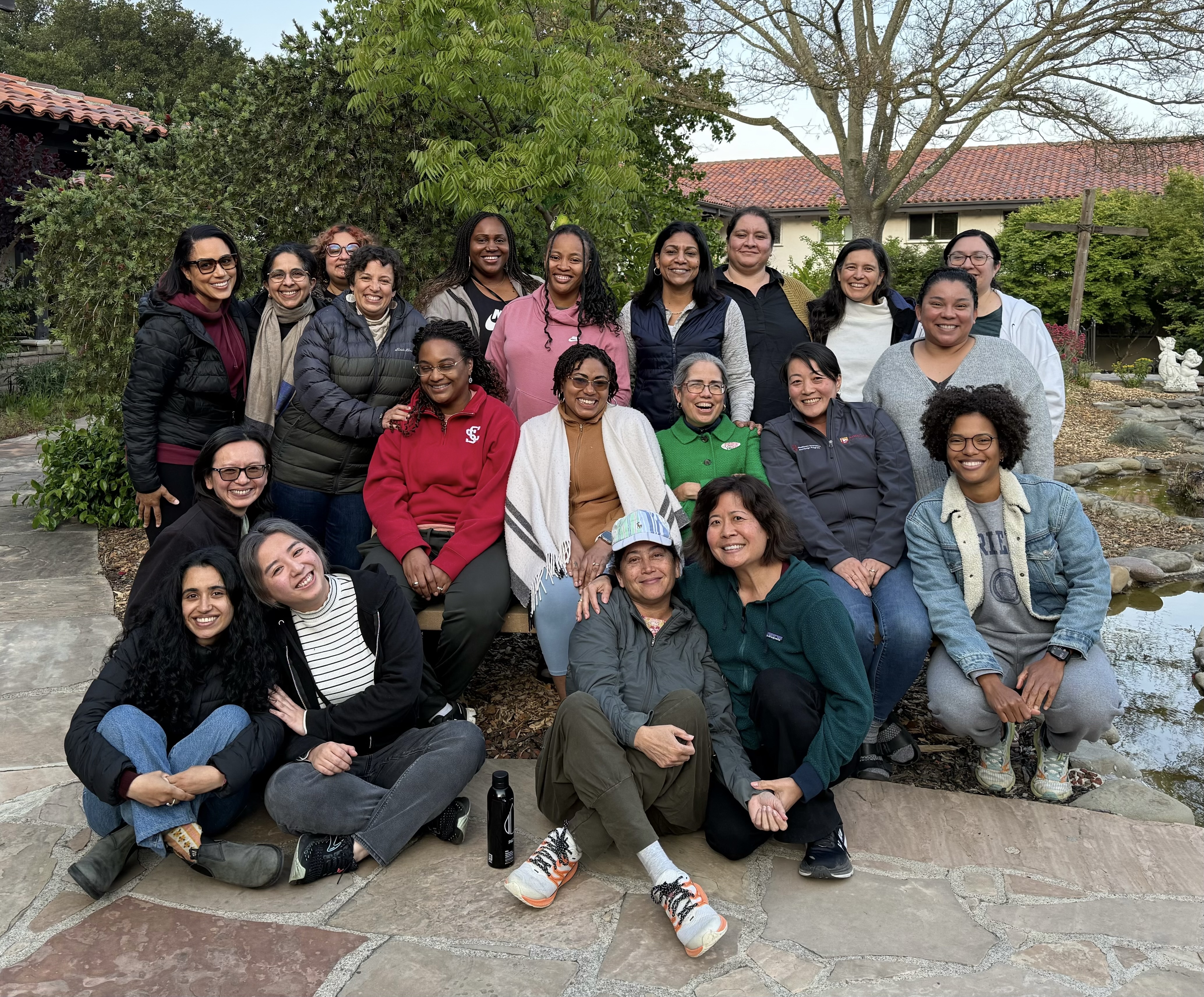 The Women of Color Faculty Group smiling together during a gathering.