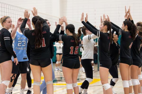 Volleyball players giving each other high-fives