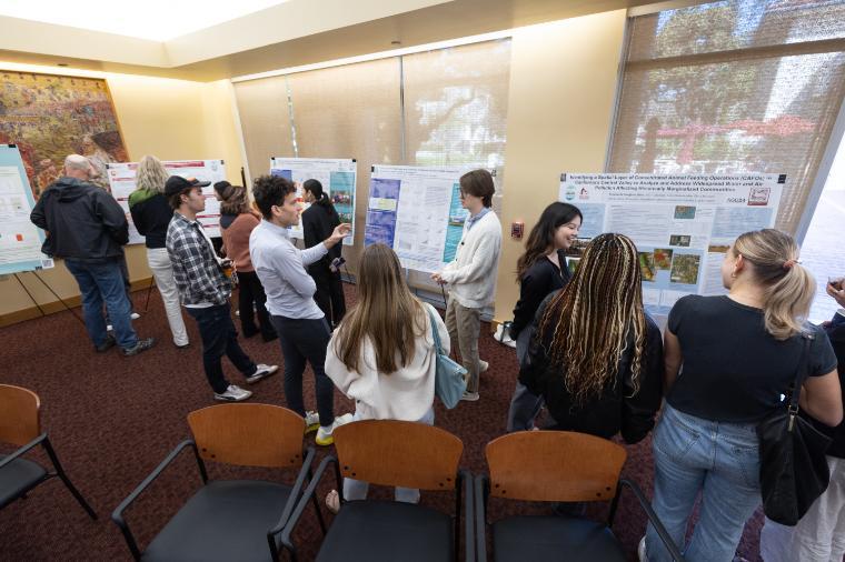 A crowd viewing student posters at the 2025 Sustainability Research Symposium