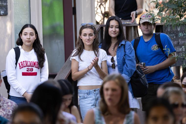 2025 Sustainability Celebration: Students standing behind the seats clapping