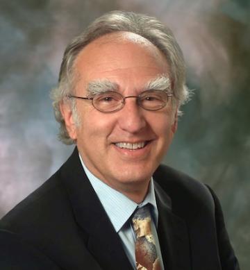 Howard Charney - man in dark suit smiling at camera