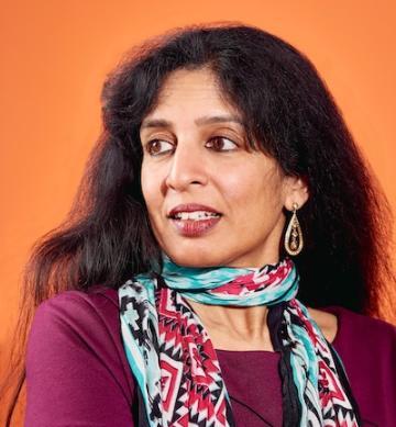 Jayshree Ullal, a woman of Indian descent looking over her shoulder
