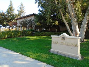 Casa Italiana building with lawn and sign in foreground.