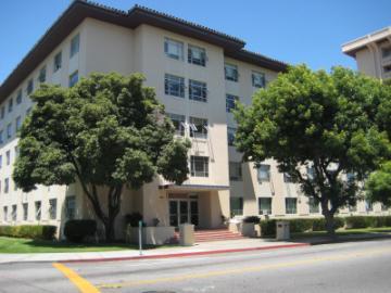 A large building named Dunne with trees in front.