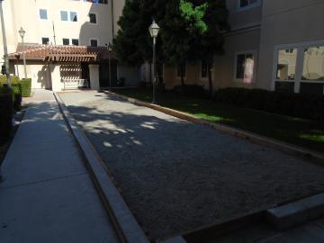 A bocci ball court with balls scattered around.