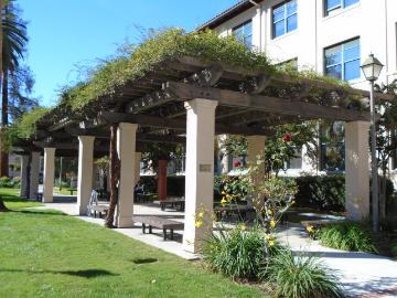 Trellis with greenery outside a building labeled Kenna Trellis.