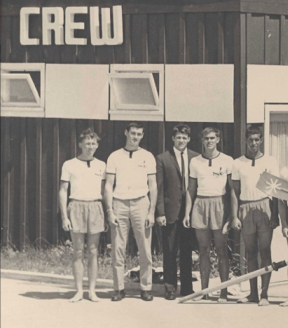 A black and white photo of a group of young men in front of a building labeled 'Crew'