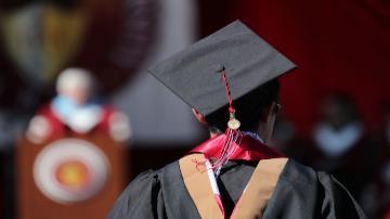 An SCU graduate looking at the commencement stage 