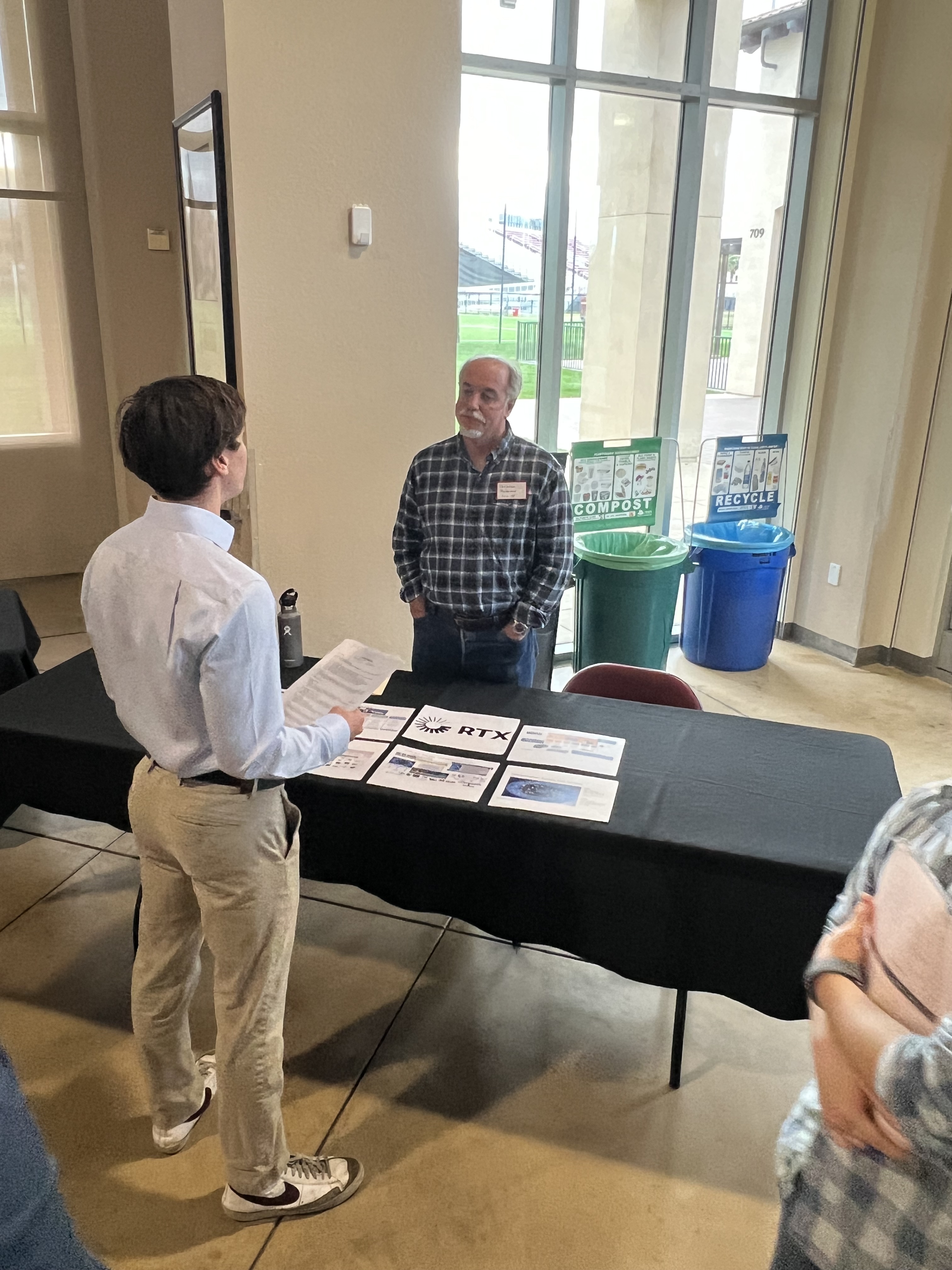 A student speaks with a representative from RTX Corporation.