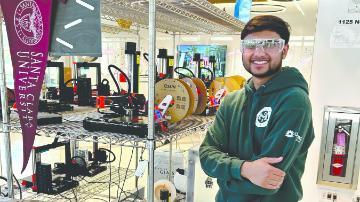 Workshop participant supervising 3D printer running