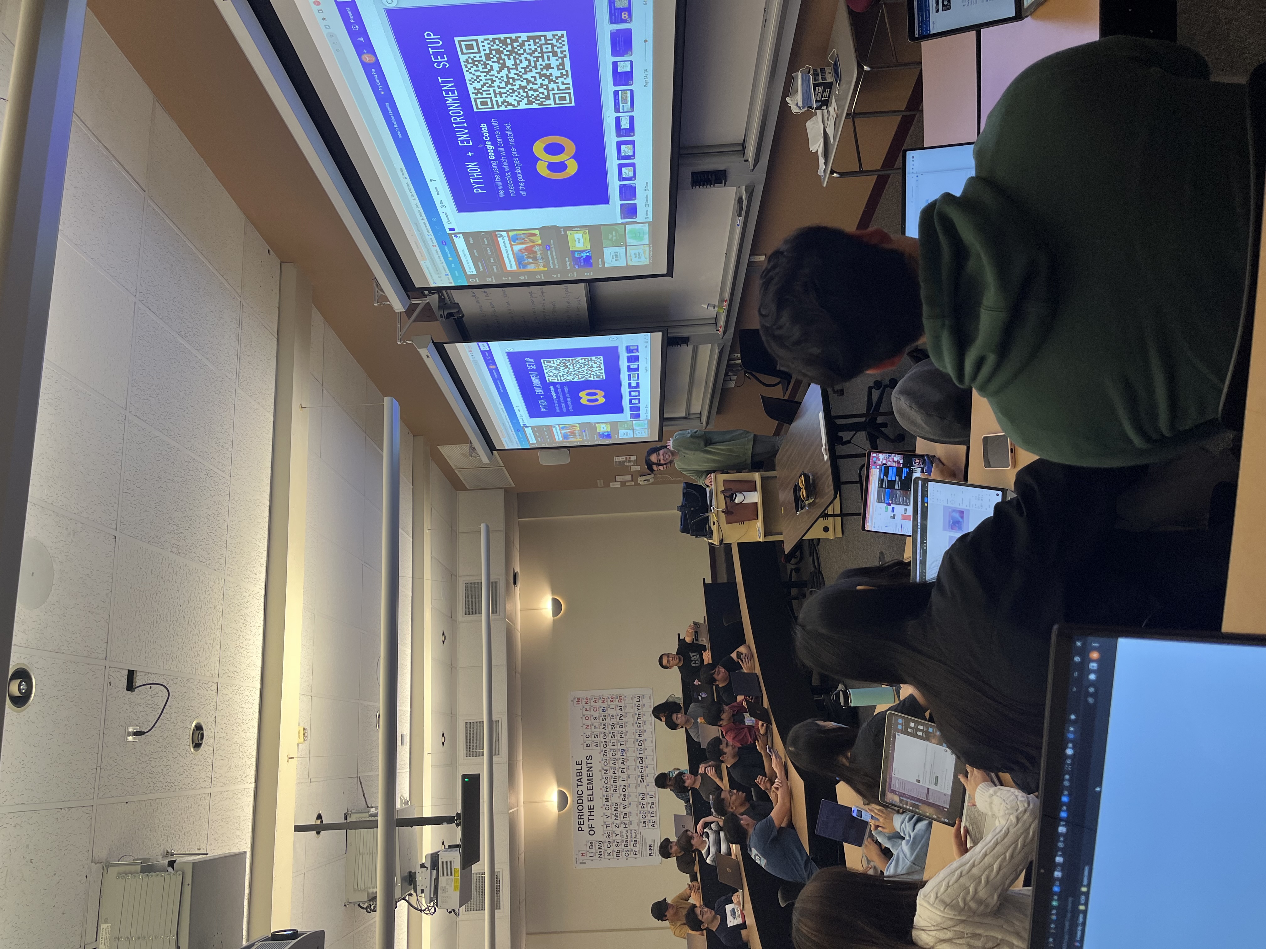 Photo of students at a workshop in a theater style classroom.