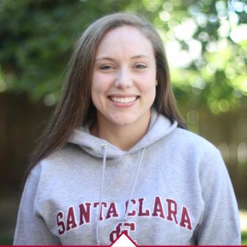 A person in a Santa Clara University hoodie smiling outdoors.