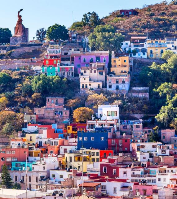 a photo of colorful houses on a hill in mexico city 