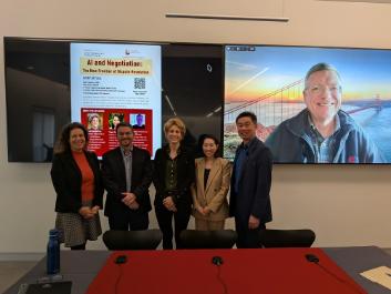 Panelists standing in front of screen