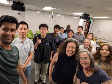 Students and professors smiling in classroom