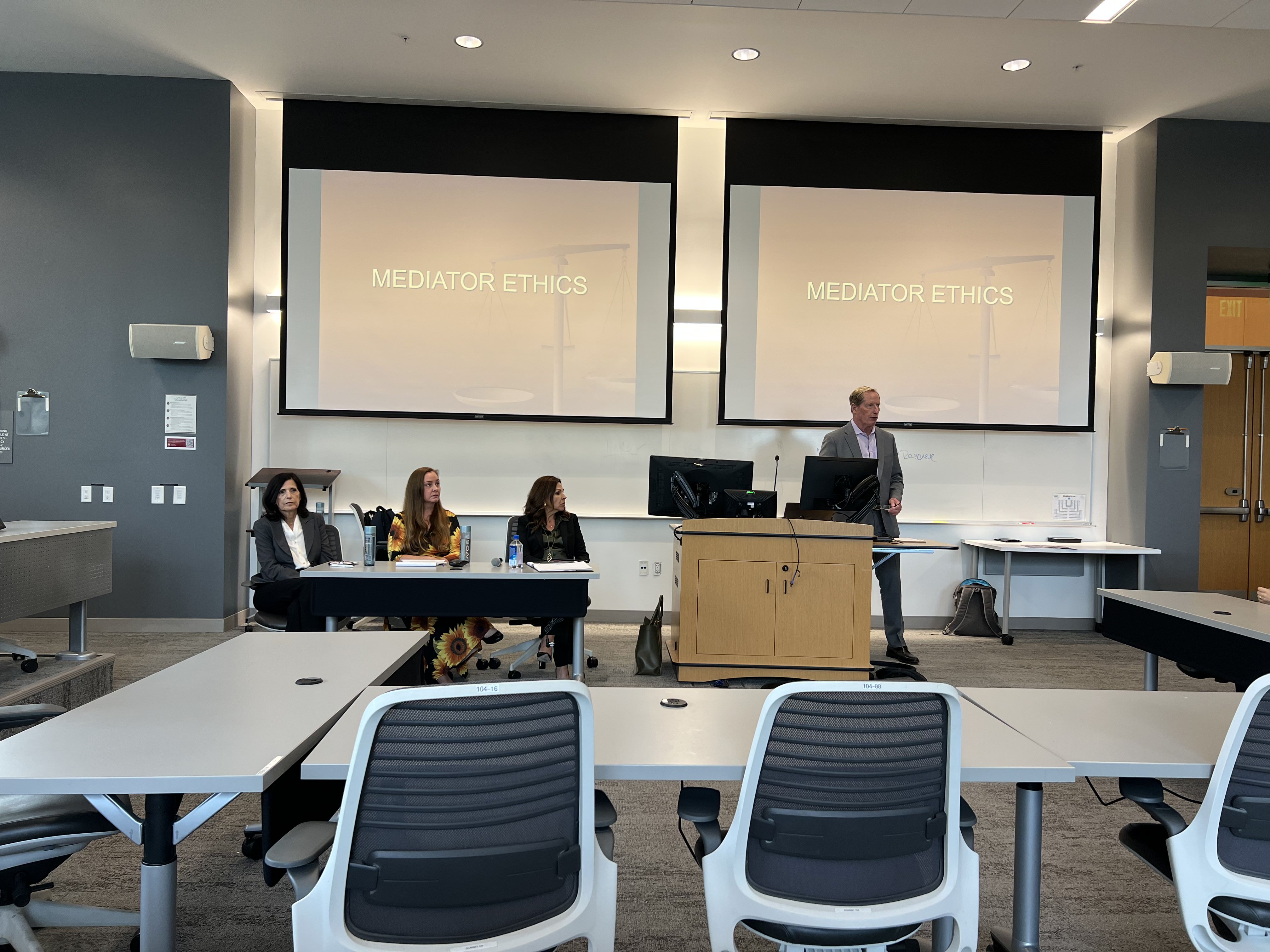 A classroom of staff and teachers doing a presentation at an event image link to story