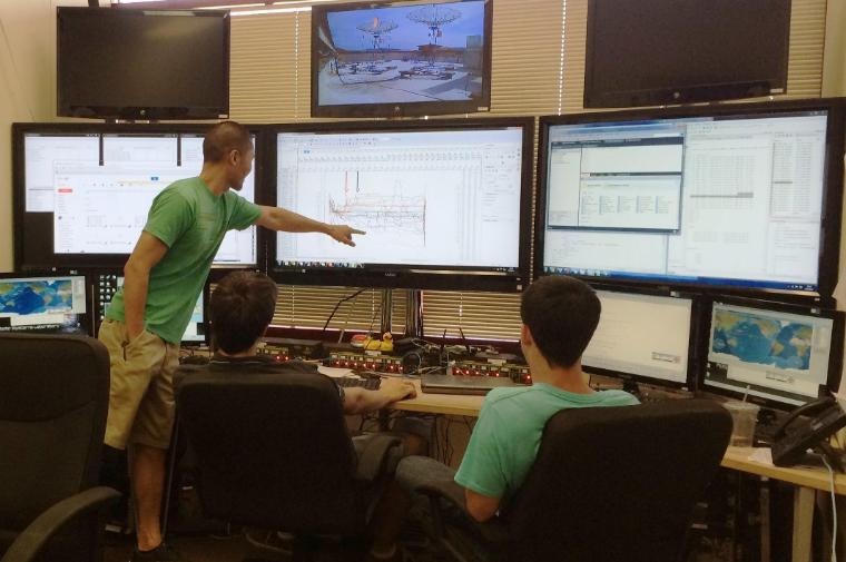 Students in SCU's Mission Control Lab sit in front of a bank of six large monitors and other equipment